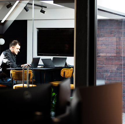 Man working on laptop in office meeting room