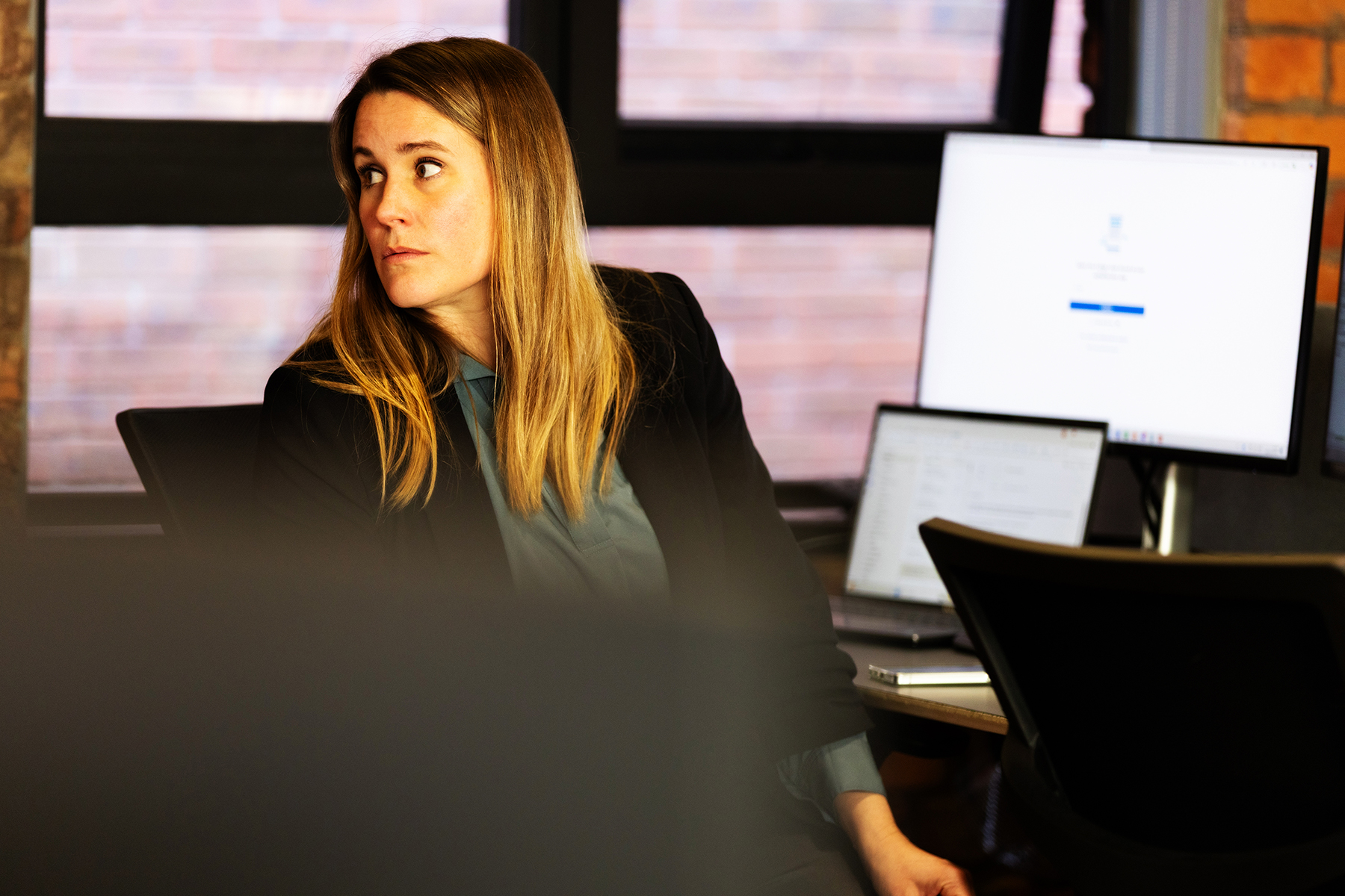 Woman at her desk looking behind